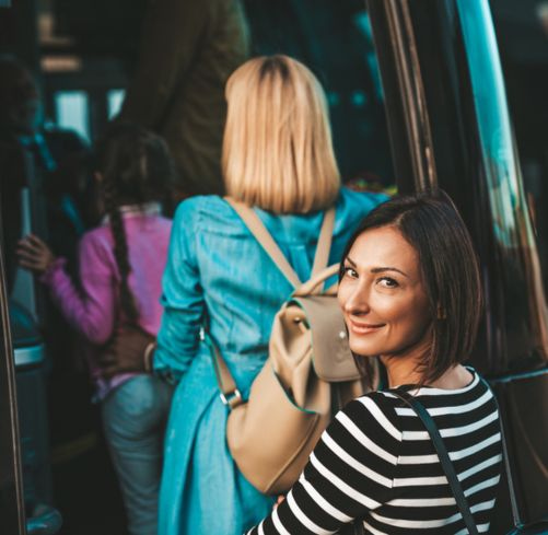 Bus passengers board a charter bus